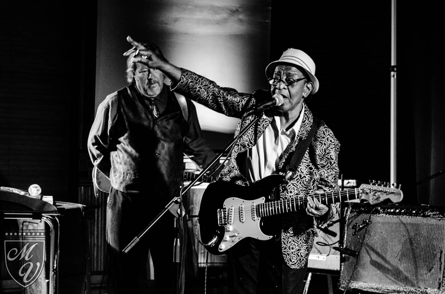 Blues guitarist singing on stage